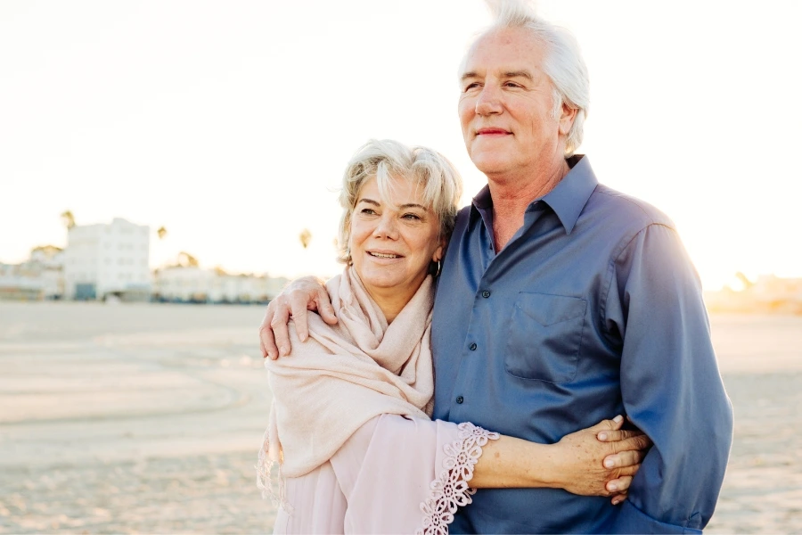 A couple gazes out at the sea. Knowing their retirement plan has been secured with a Raleigh CPA puts them at ease. 