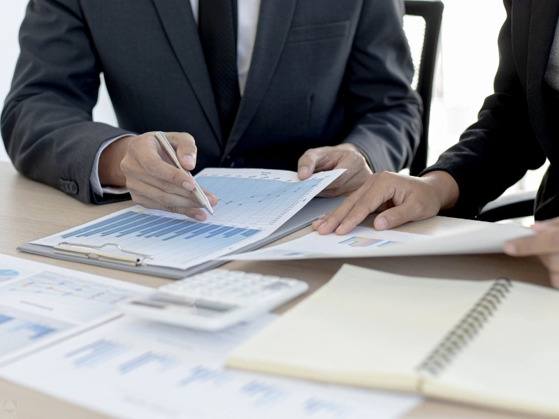 Two trust advisors review documents. Trust benefits, advantage of a trust, benefits of having a trust.