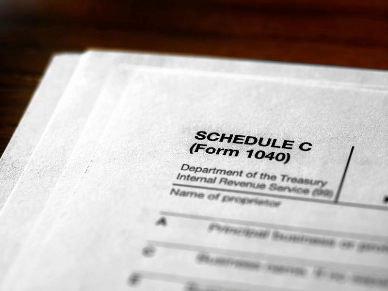 Schedule C tax form. Image accompanies the blog addressing "how much can a tax preparer charge legally"
