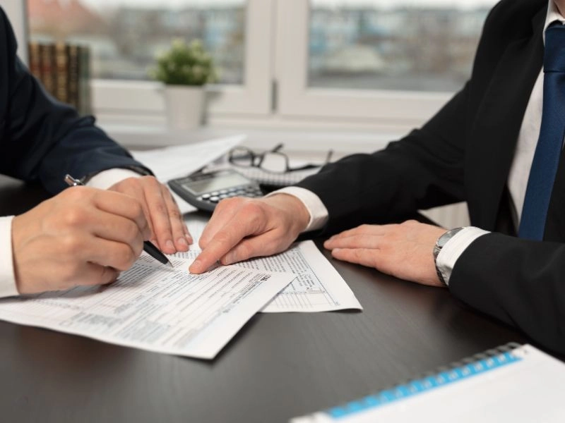 Masculine hands filing taxes to claim the social security tax deduction for seniors