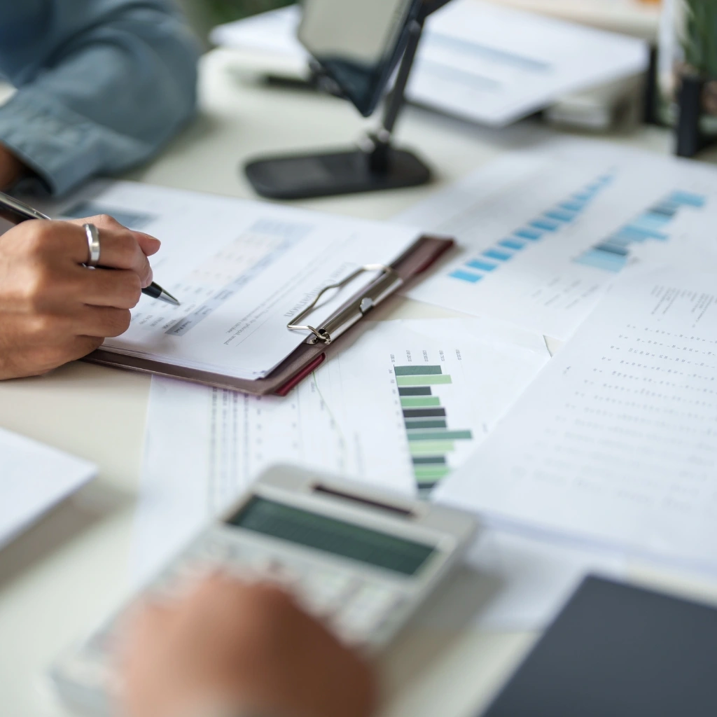 Accountants working with spreadsheets and calculators to provide tax preparation services in Raleigh and Durham.
