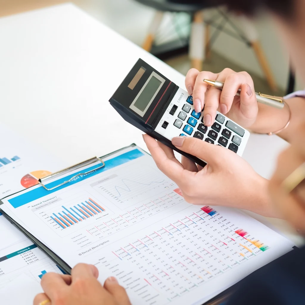 Accountant prepares taxes using calculator and a spreadsheet, thereby providing a tax preparation service