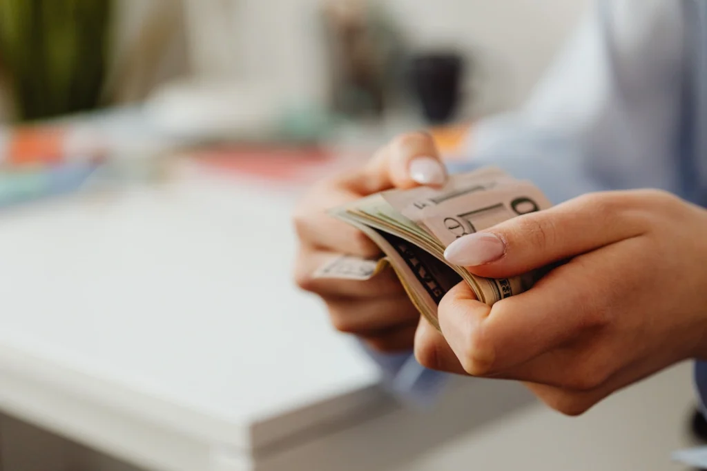 Holding money. Image complements the blog regarding Multi State Tax Filing.
